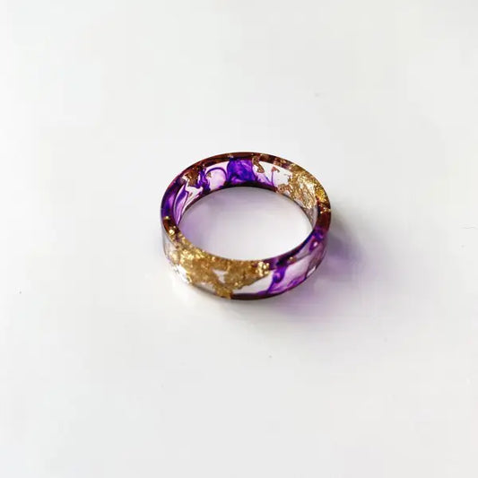 Colorful handmade resin ring with dried flowers and gold foil
